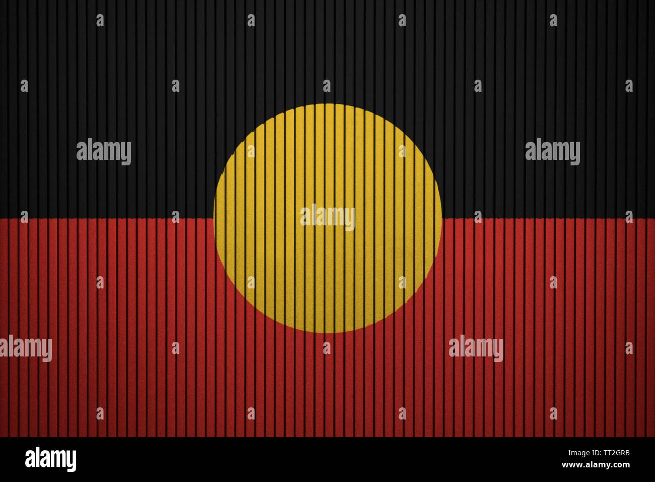 Australian Aboriginal flag painted on the cracked grunge concrete wall Stock Photo
