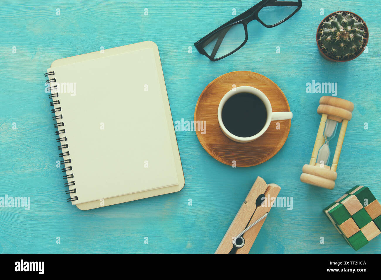 Open notebook with empty pages and other office supplies over blue office desk table. Top view Stock Photo