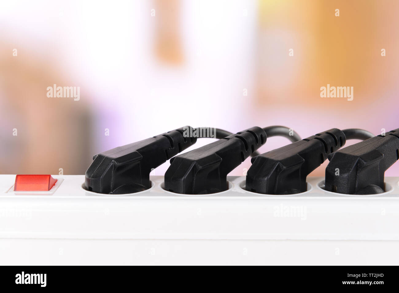 Many plugs plugged into electric power bar closeup Stock Photo Alamy