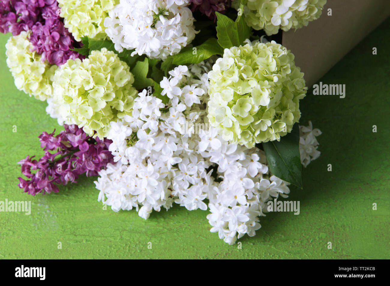 Beautiful bouquet of spring flowers on color wooden background Stock ...