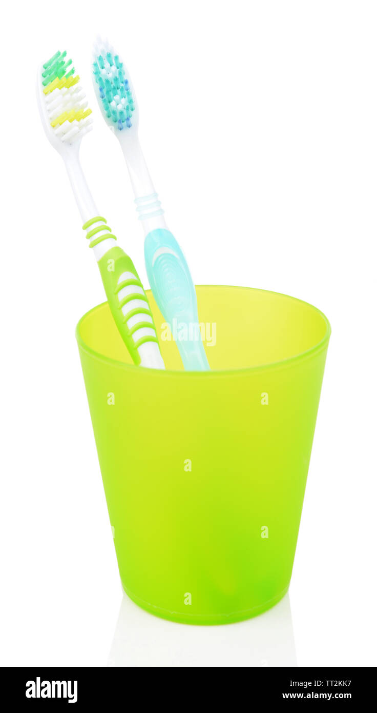 Toothbrushes in glass isolated on white Stock Photo - Alamy