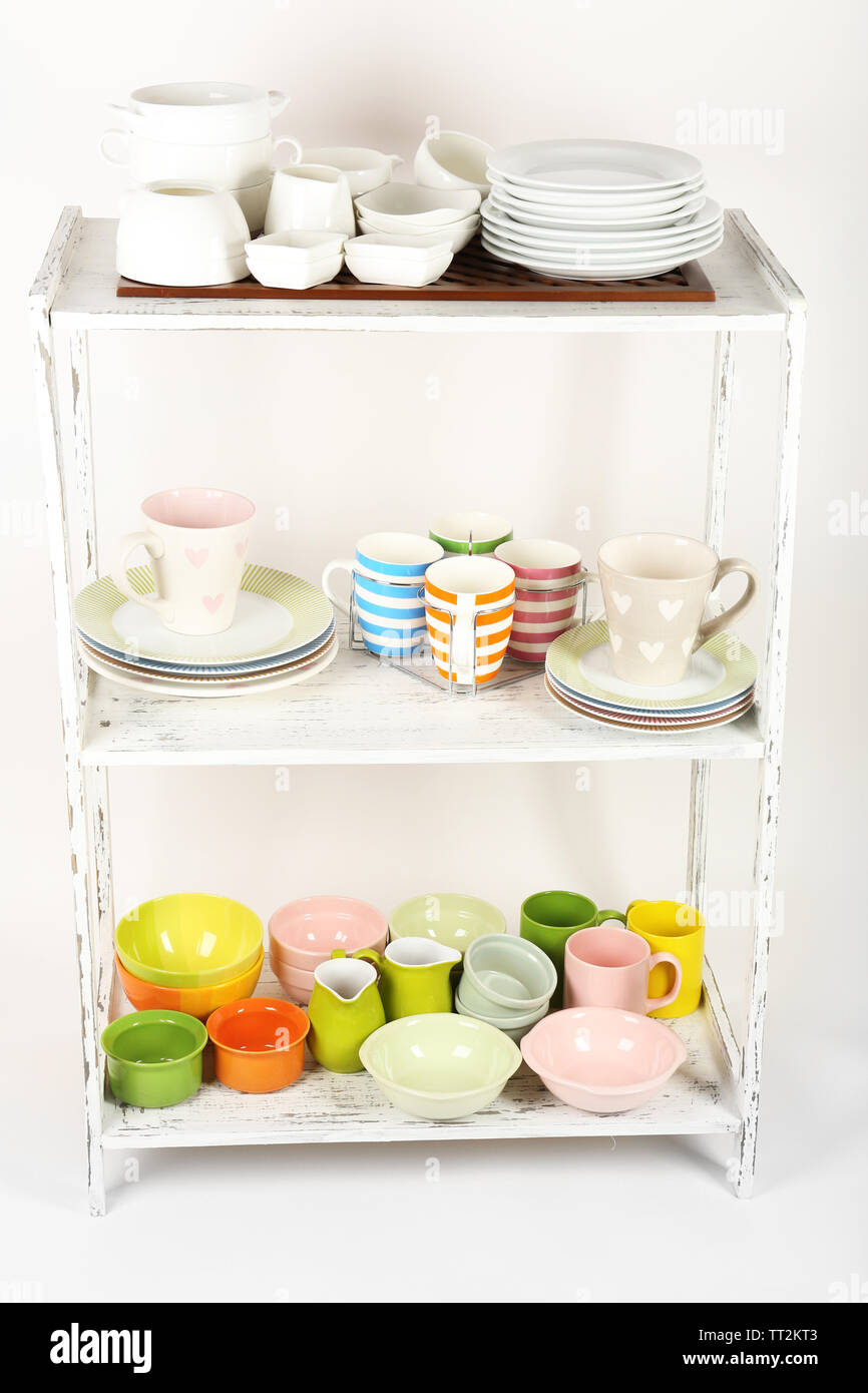 Different tableware on shelves, isolated on white Stock Photo - Alamy