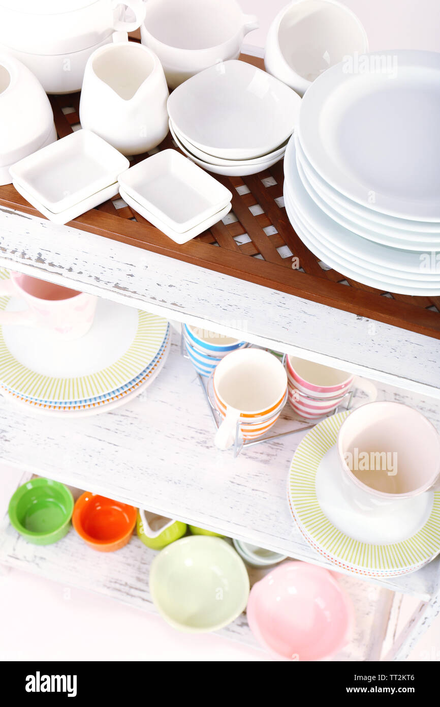 Different tableware on shelf, close up Stock Photo - Alamy