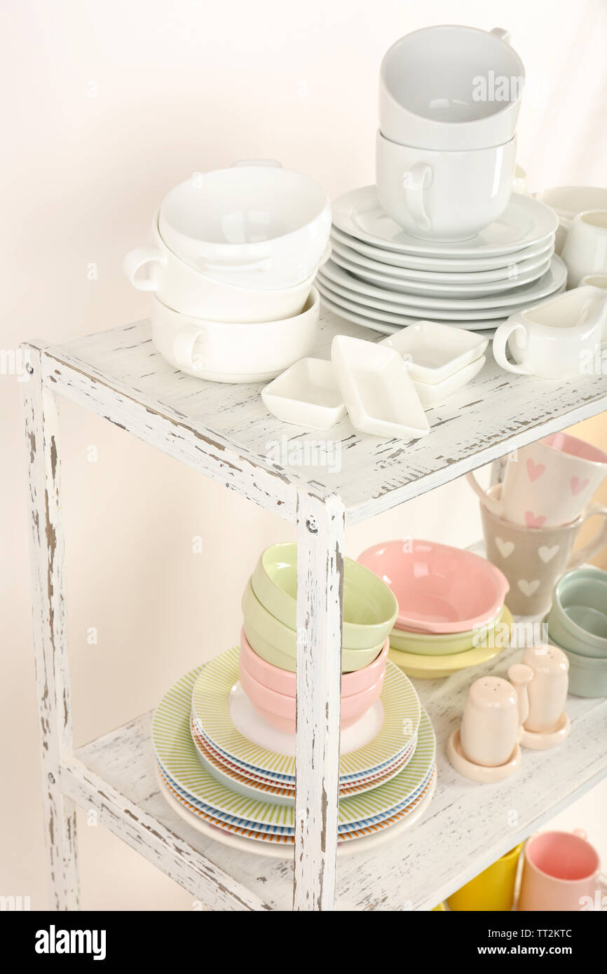 Different tableware on shelf, isolated on white Stock Photo - Alamy