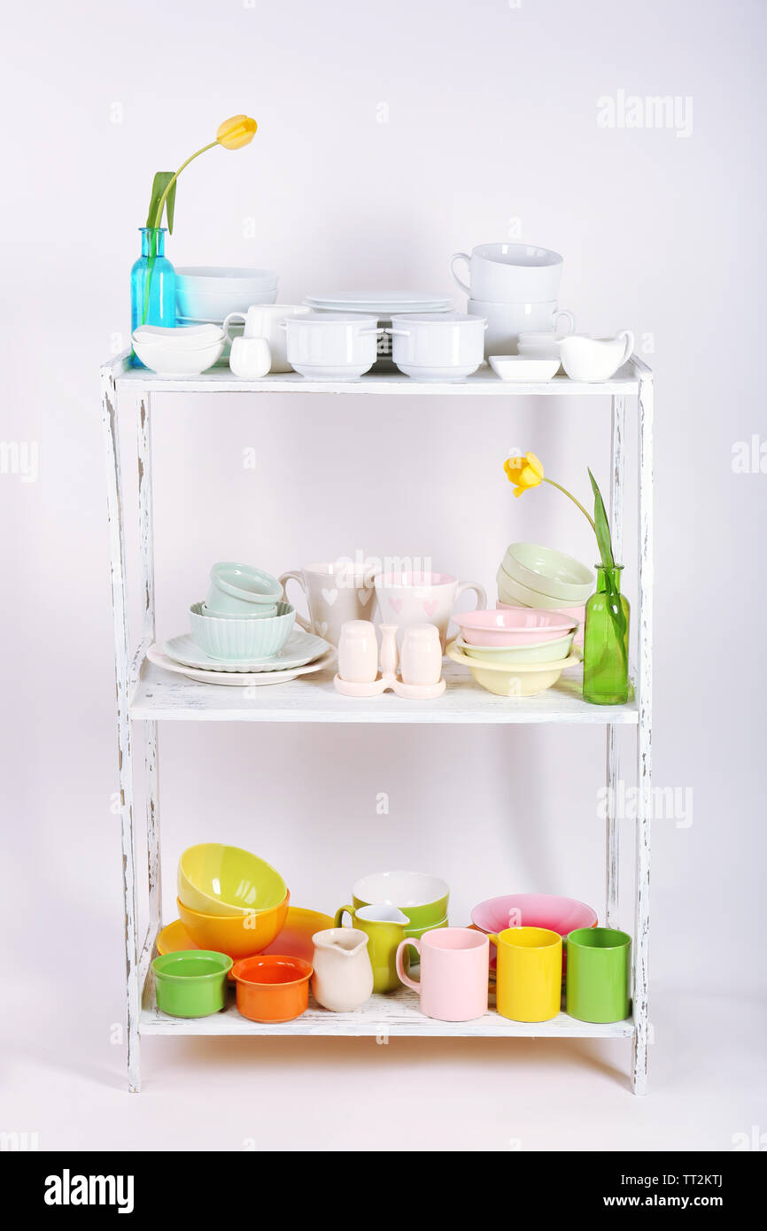 Different tableware on shelf, isolated on white Stock Photo - Alamy