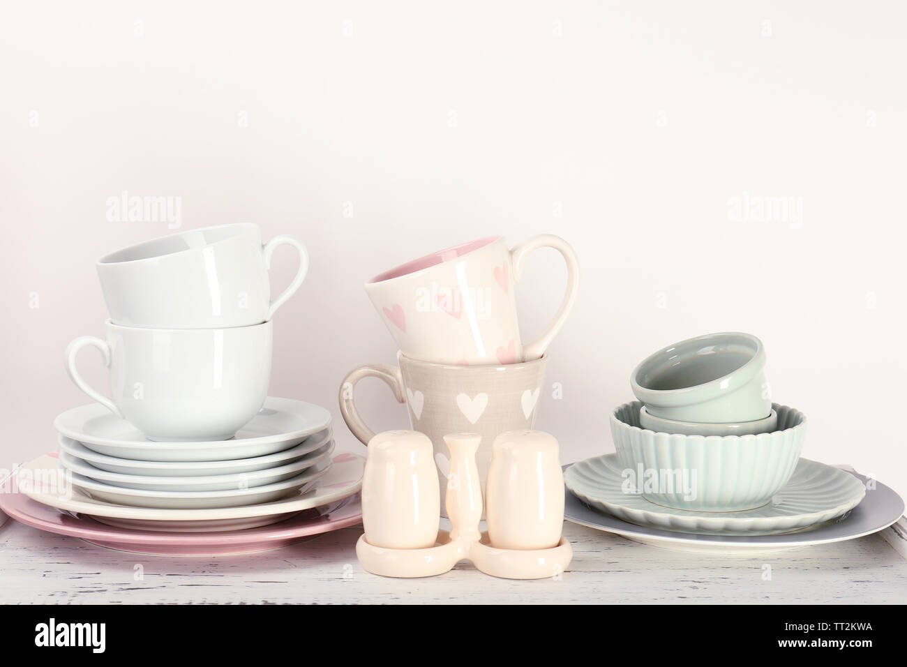 Different tableware on shelf, isolated on white Stock Photo - Alamy