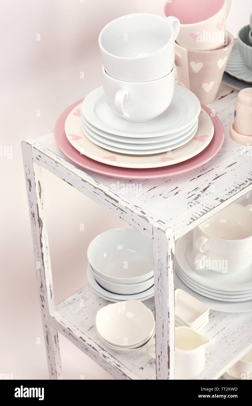 Different tableware on shelf, close up Stock Photo - Alamy