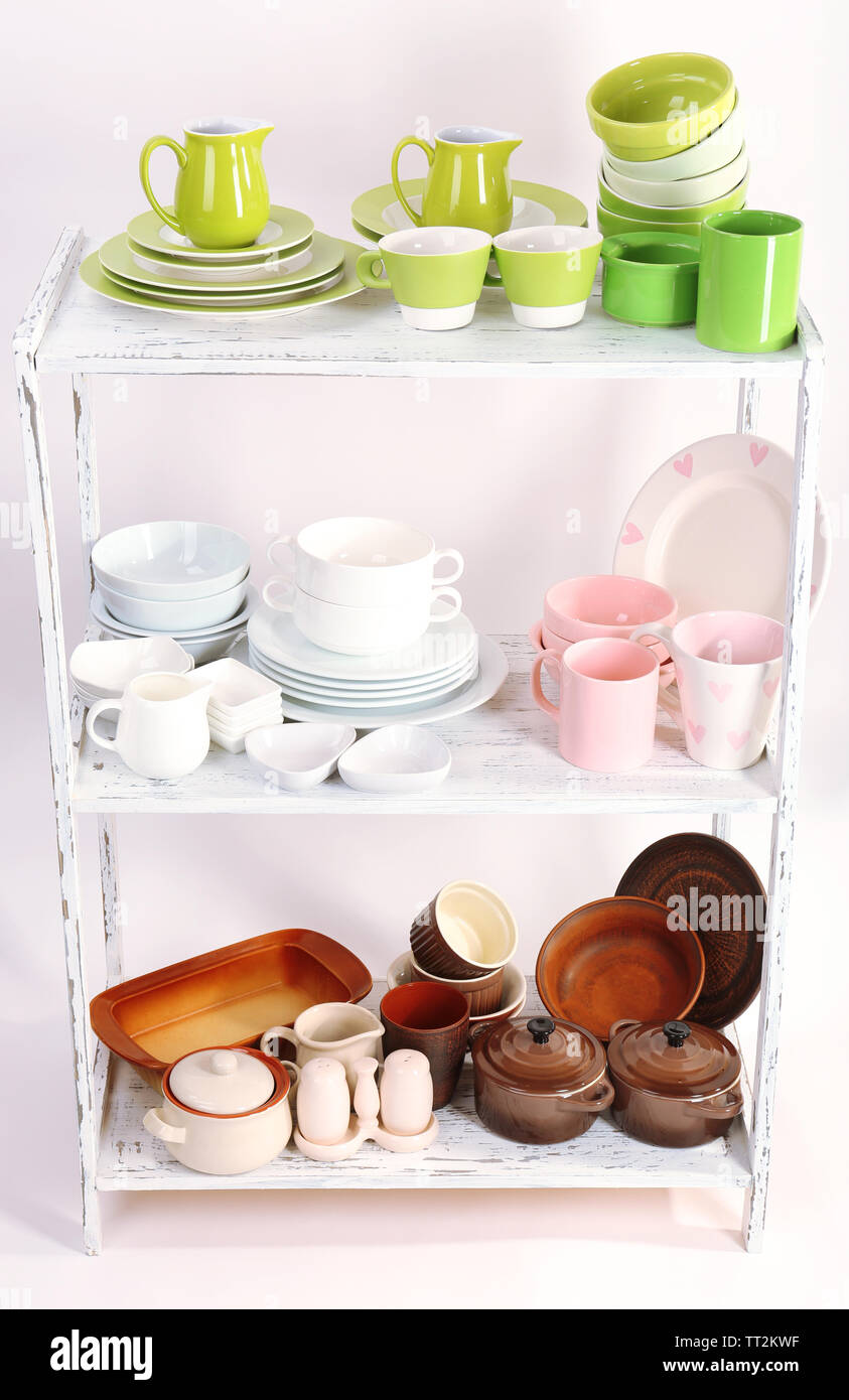 Different tableware on shelf, isolated on white Stock Photo - Alamy