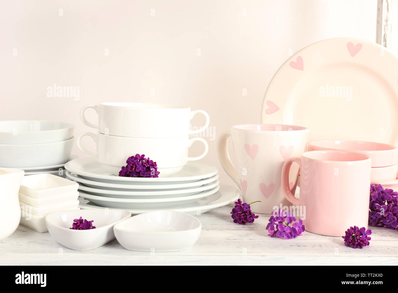 Different tableware on shelf, isolated on white Stock Photo - Alamy