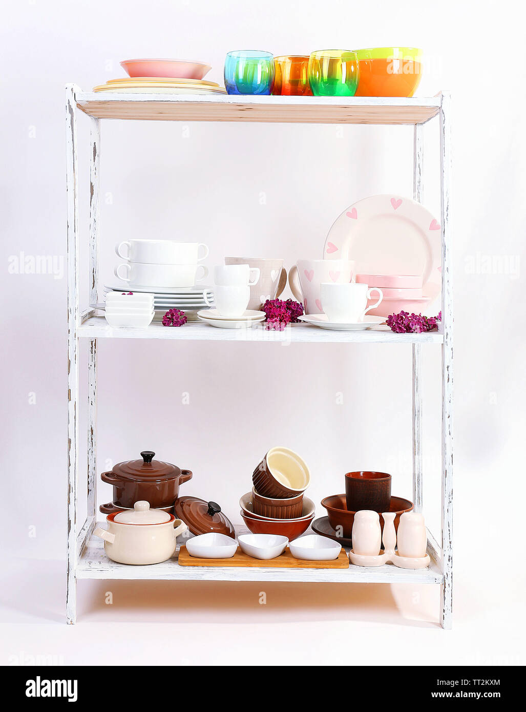 Different tableware on shelf, isolated on white Stock Photo - Alamy