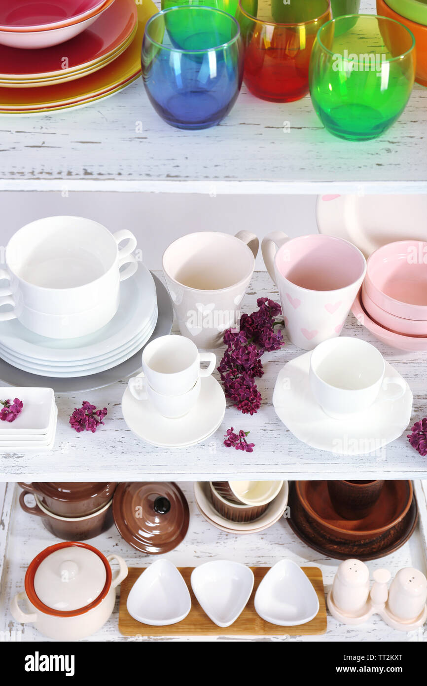 Different tableware on shelf, close up Stock Photo - Alamy