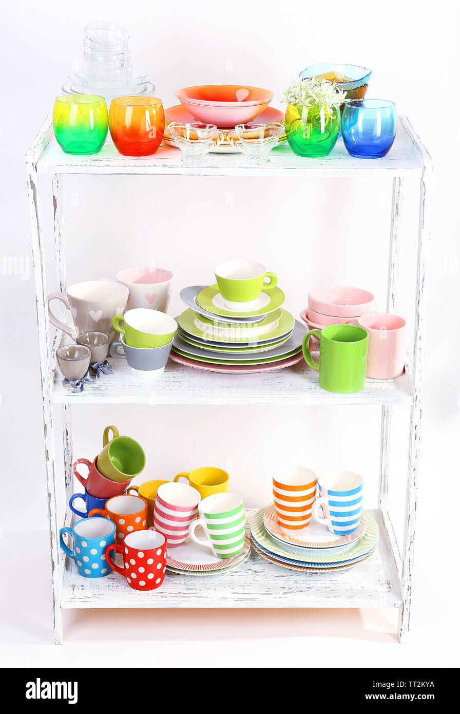 Different tableware on shelf, isolated on white Stock Photo - Alamy