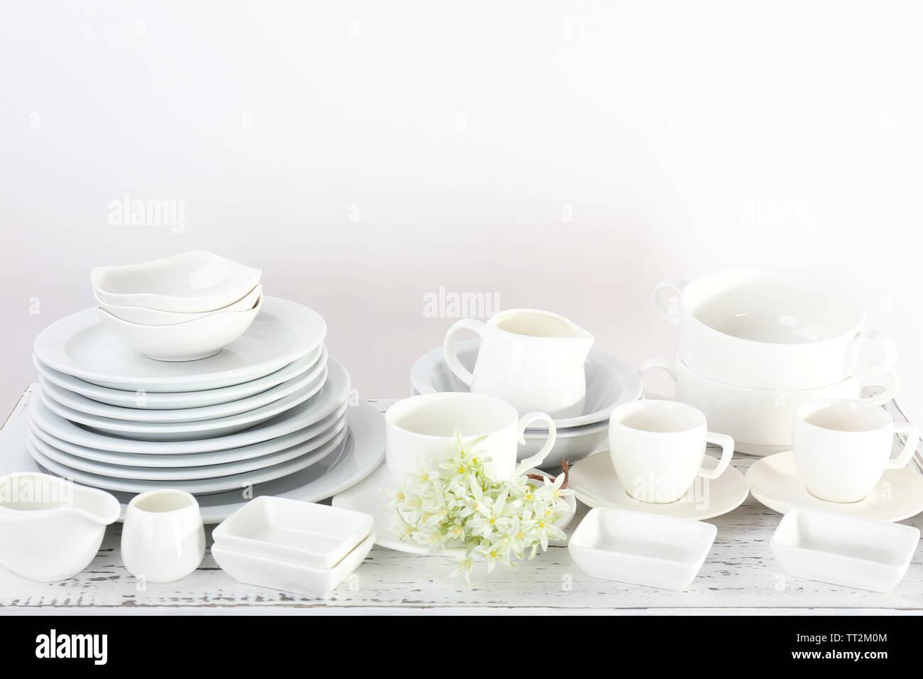 Different tableware on shelf, isolated on white Stock Photo - Alamy