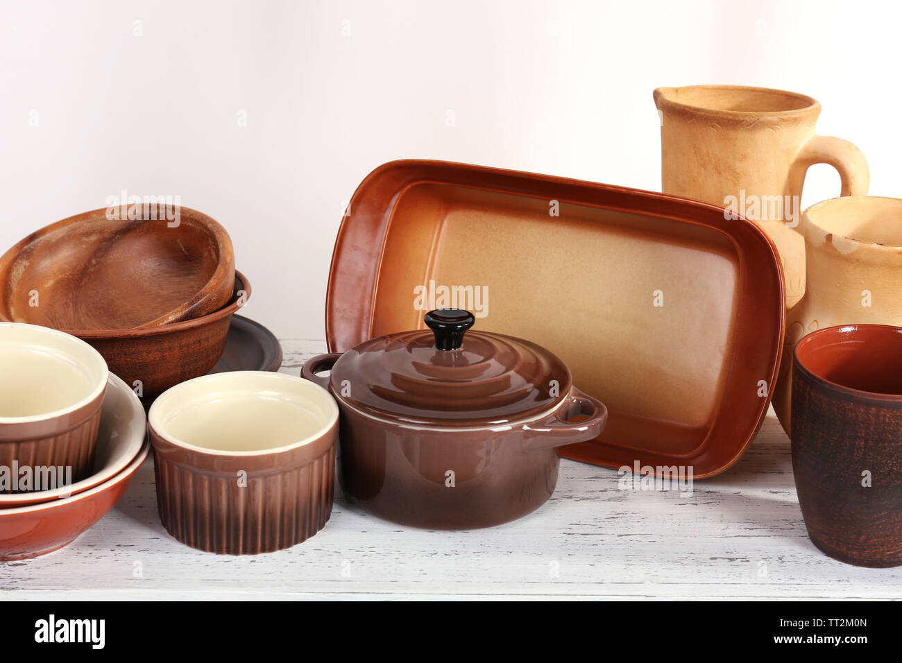 Different tableware on shelf, isolated on white Stock Photo - Alamy