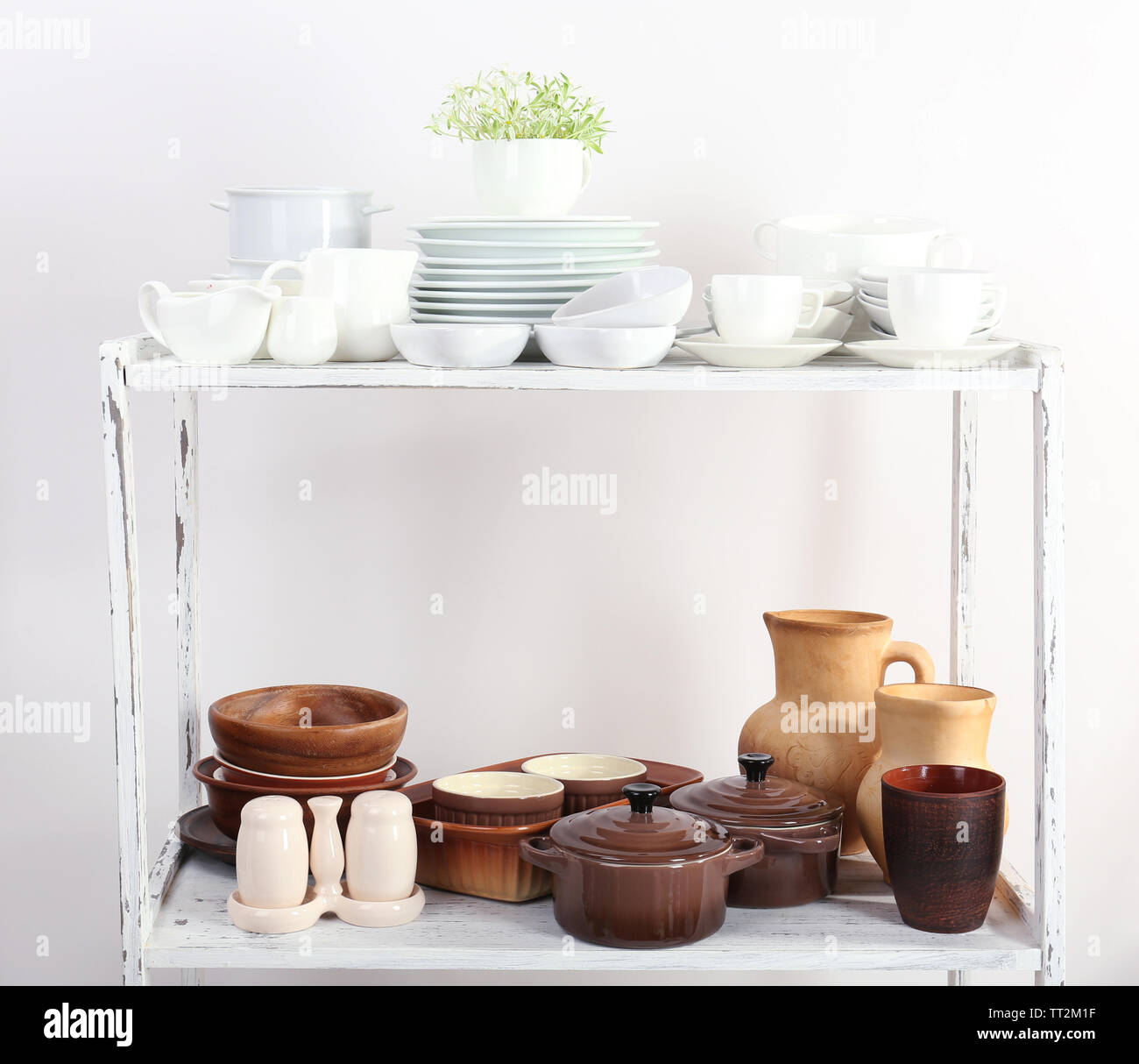Different tableware on shelf, isolated on white Stock Photo - Alamy