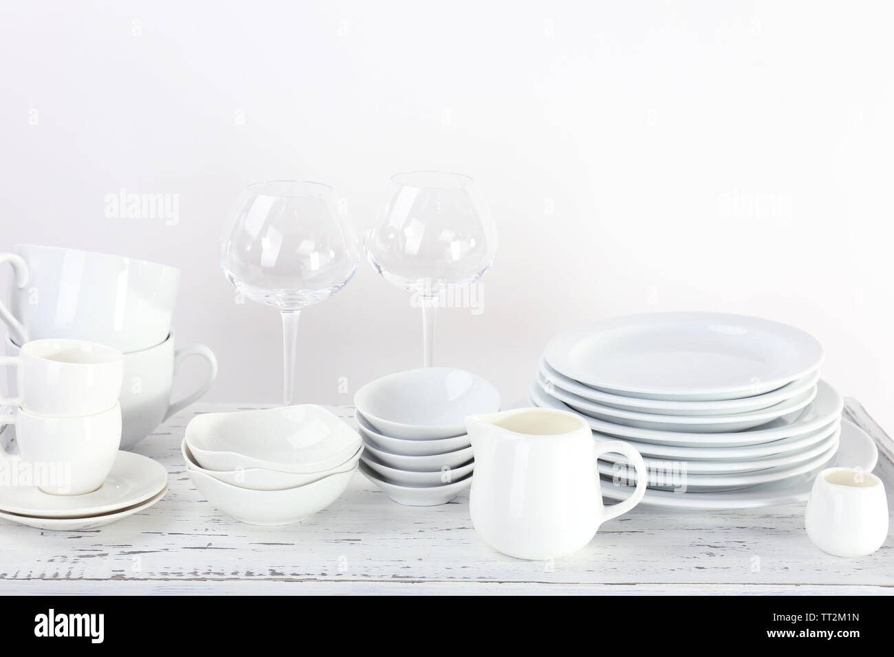 Different tableware on shelf, isolated on white Stock Photo - Alamy