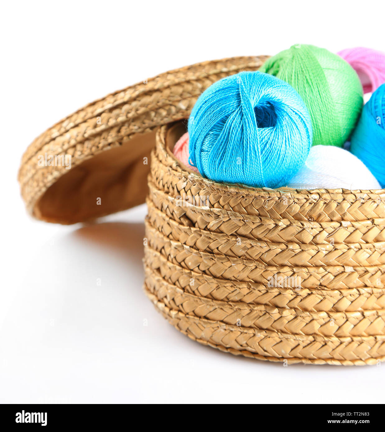 Colorful yarn balls for knitting in wicker basket, isolated on white ...