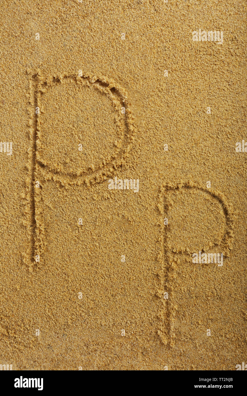 Alphabet letter written on wet beach sand Stock Photo