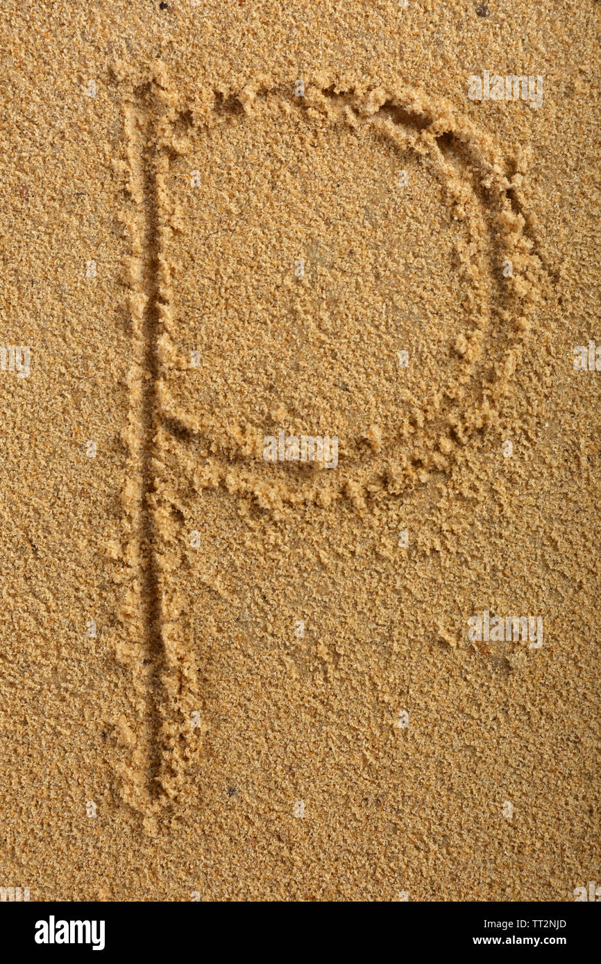 Alphabet letter written on wet beach sand Stock Photo
