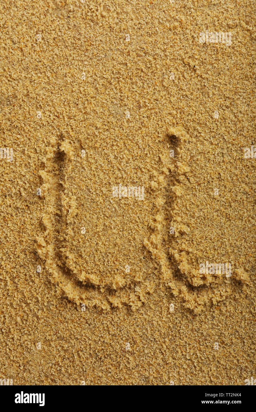 Alphabet letter written on wet beach sand Stock Photo - Alamy