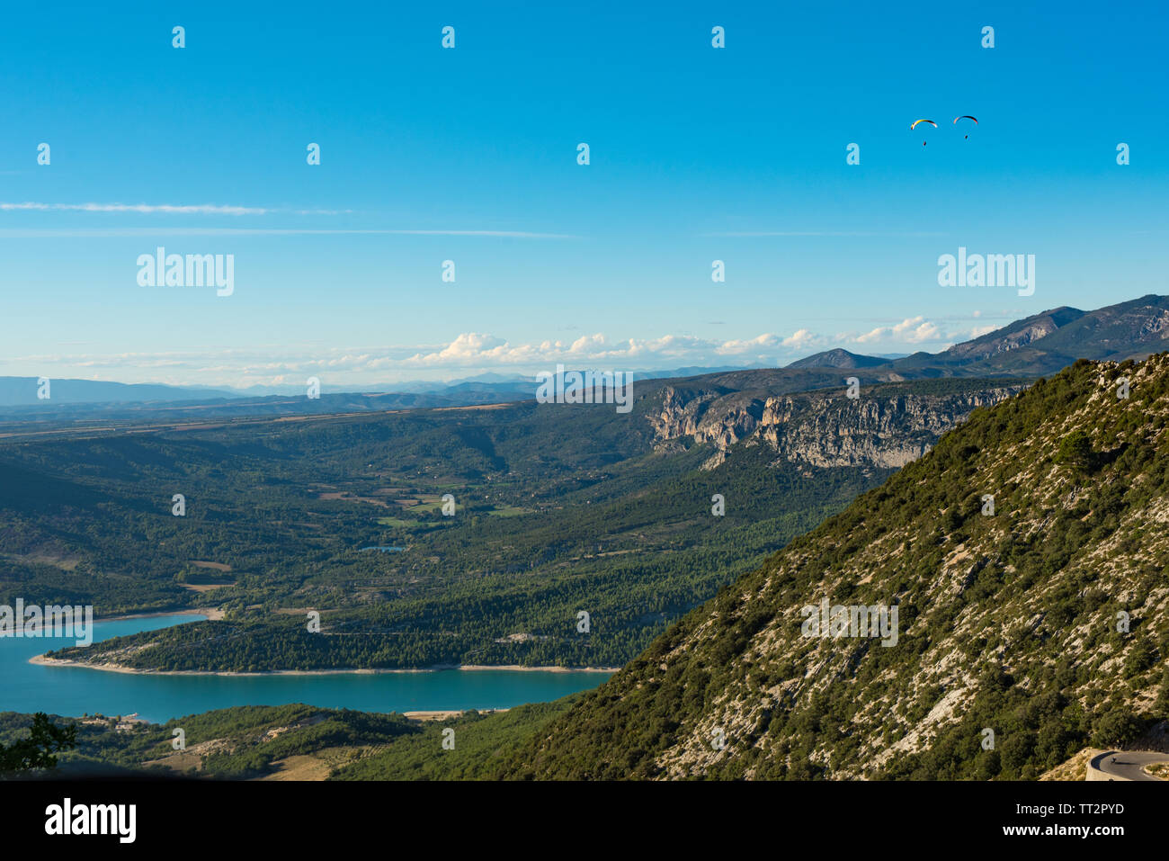 Two paratroopers flying over the blue Lac de Sainte-Croix lake near Verdon gorges in Provence, France Stock Photo