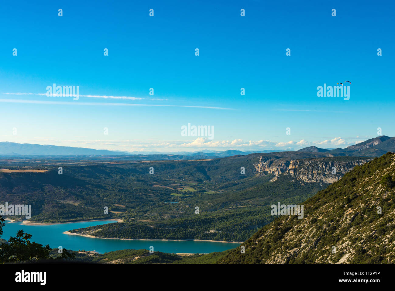 Two paratroopers flying over the blue Lac de Sainte-Croix lake near Verdon gorges in Provence, France Stock Photo