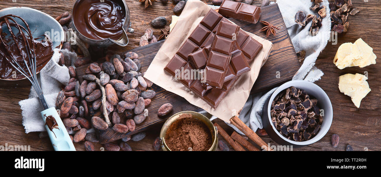 Cacao beans, powder, cacao butter, chocolate bar and chocolate sauce on