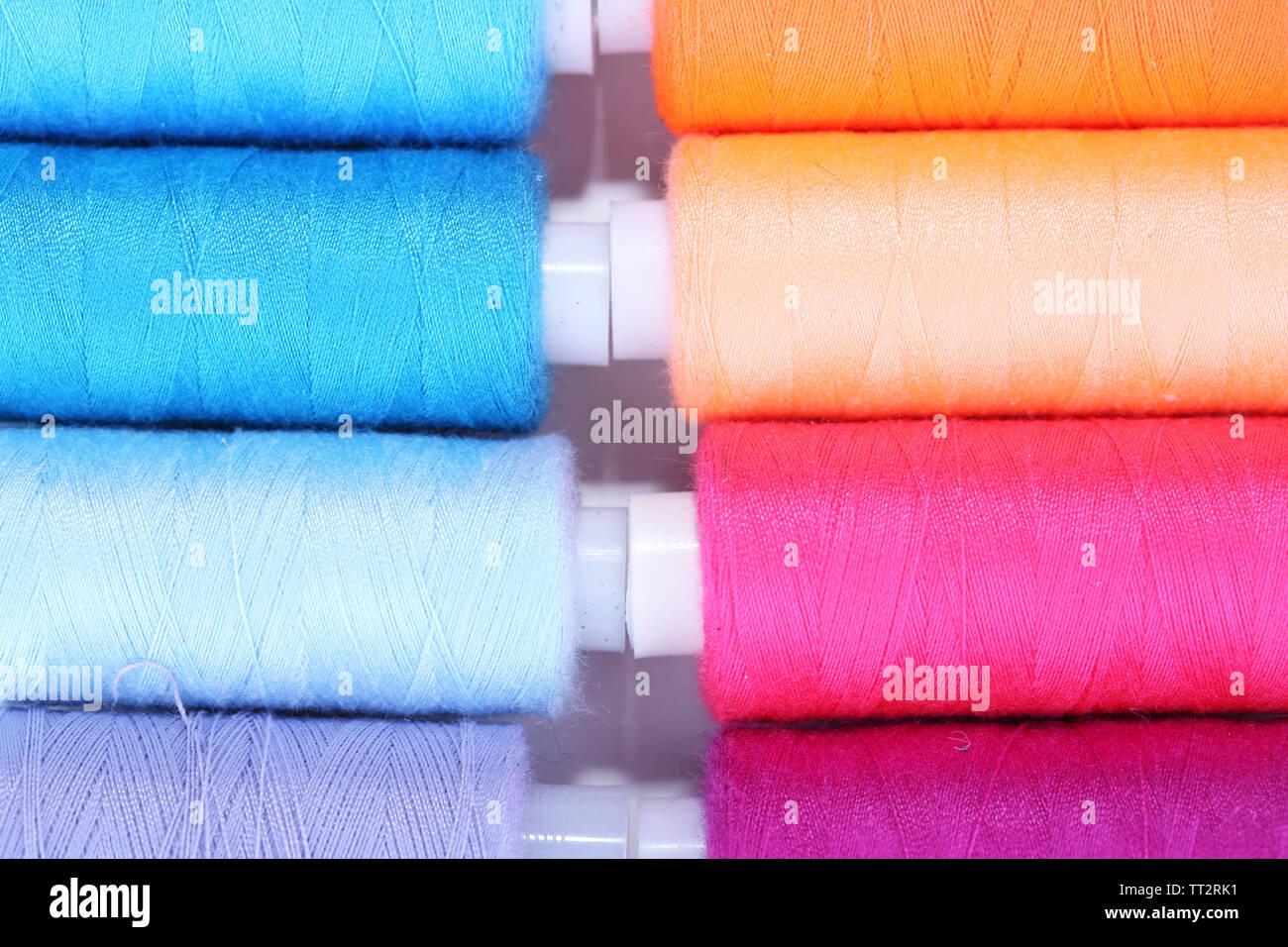 Multicolor sewing threads background Stock Photo - Alamy
