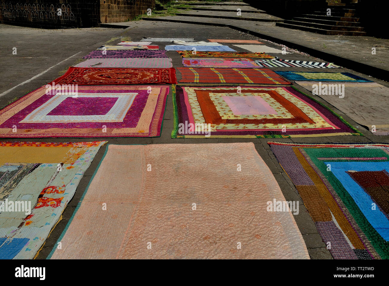 Colourful carpets and blankets displayed on the bank of Krishna river, Menavali, Wai, Maharashtra, India Stock Photo