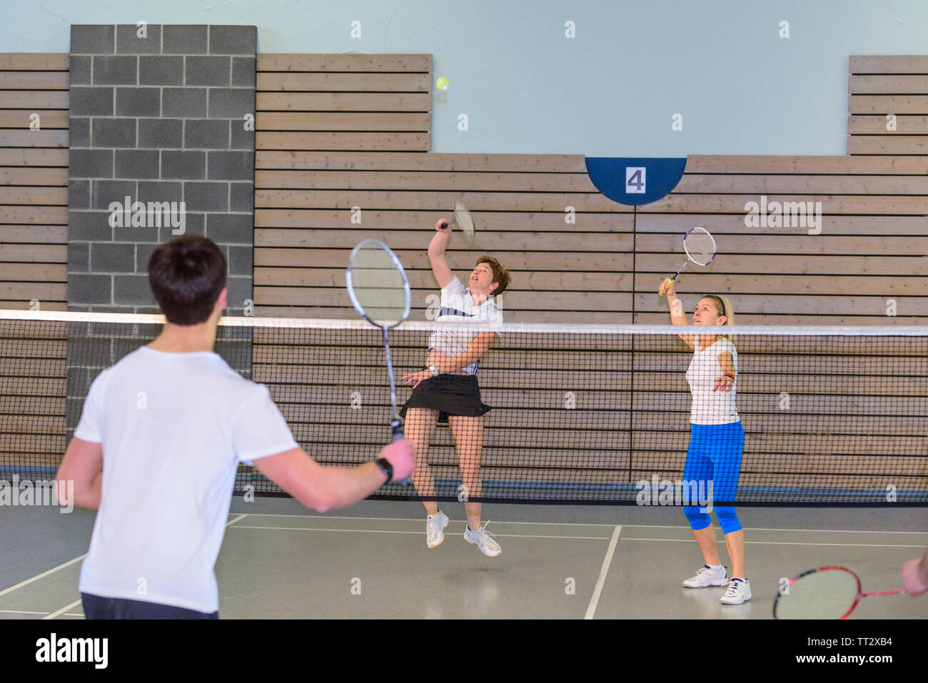 Badminton game scene in sports hall, a lot of effort and commitment during an intense game Stock Photo