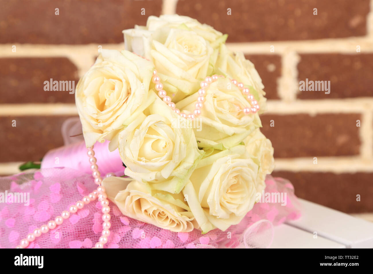 Beautiful Wedding Bouquet With Roses On Bricks Wall Background Stock Photo Alamy