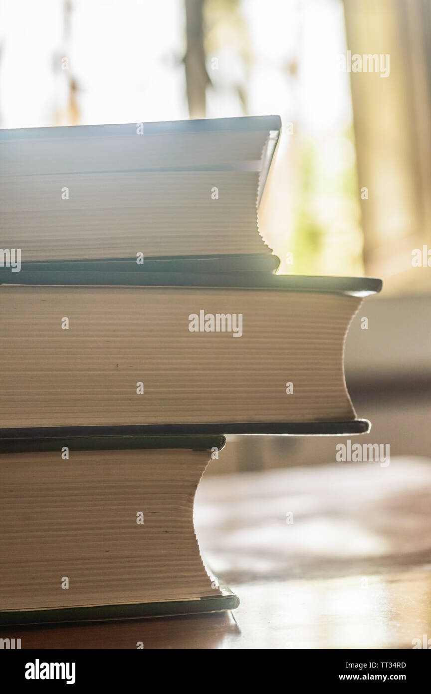 Many Hardcover Old books on grunge wooden table desk shelf in library