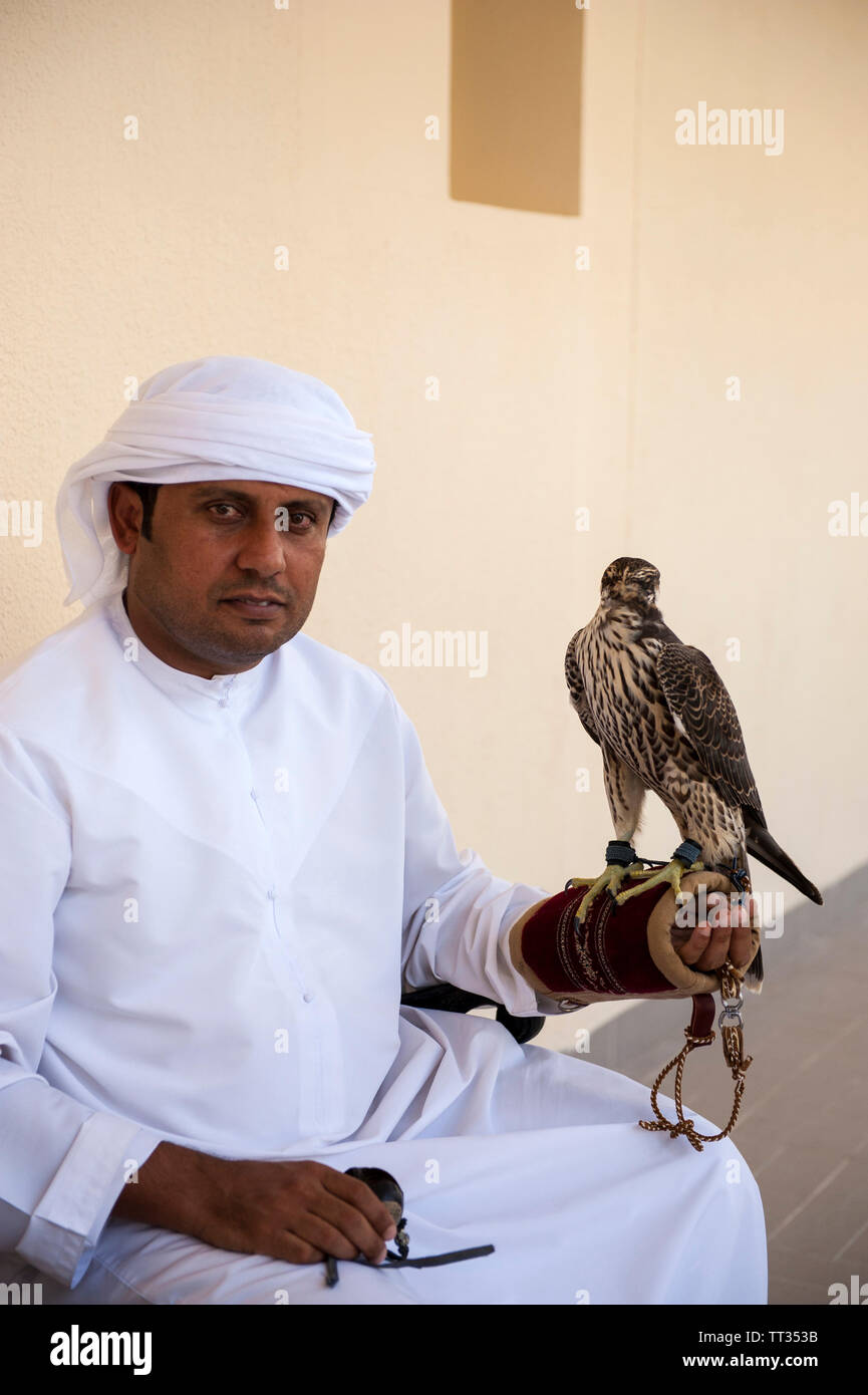 An Emirati man with his falcon waiting for a medical check-up at the Abu Dhabi Falcon Hospital, Abu Dhabi, United Arab Emirates. Stock Photo