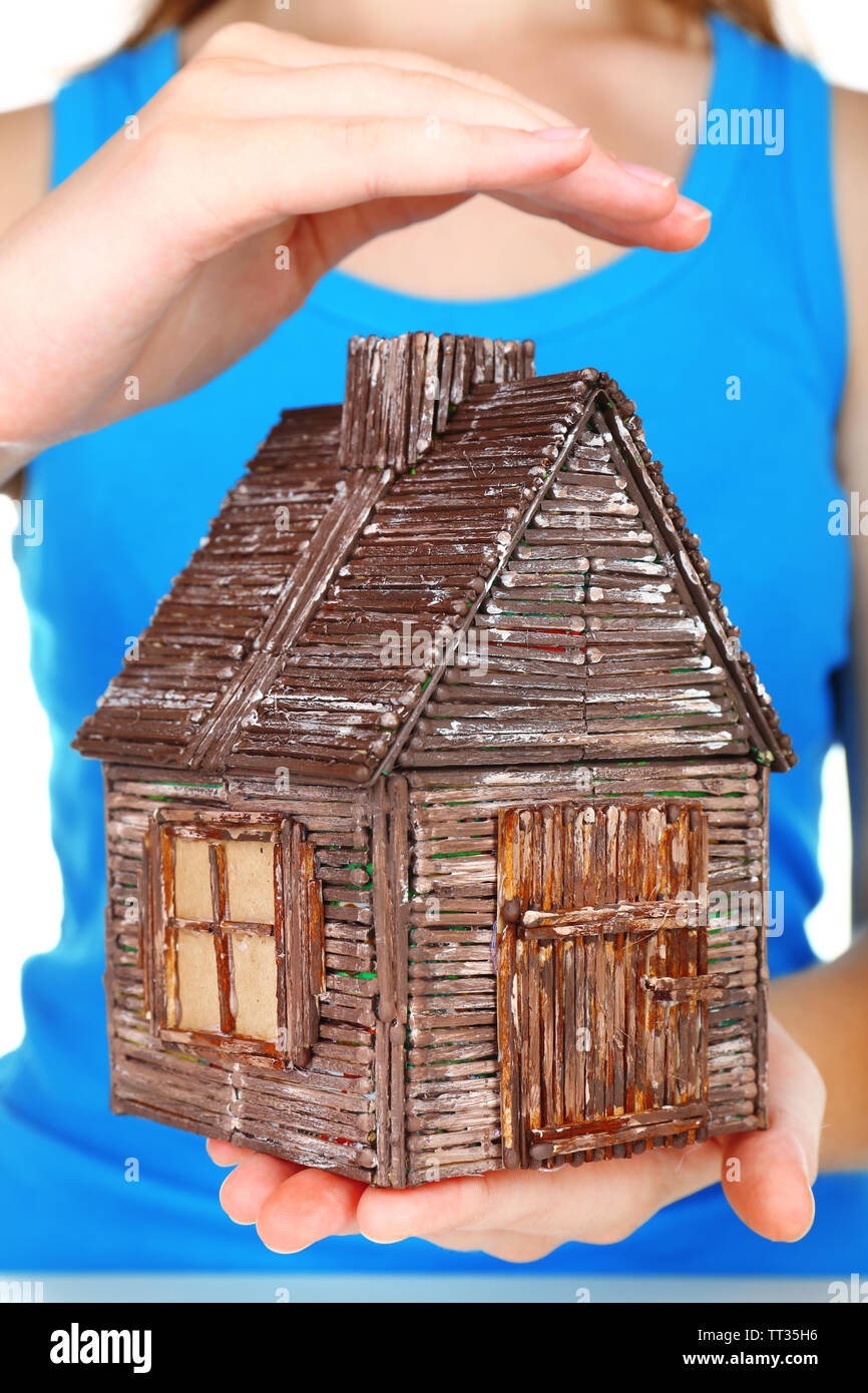 Small wooden house in hands, close up Stock Photo - Alamy