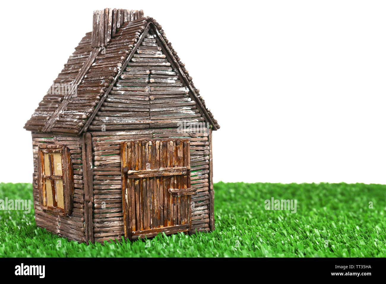 Small wooden house on grass isolated on white Stock Photo - Alamy