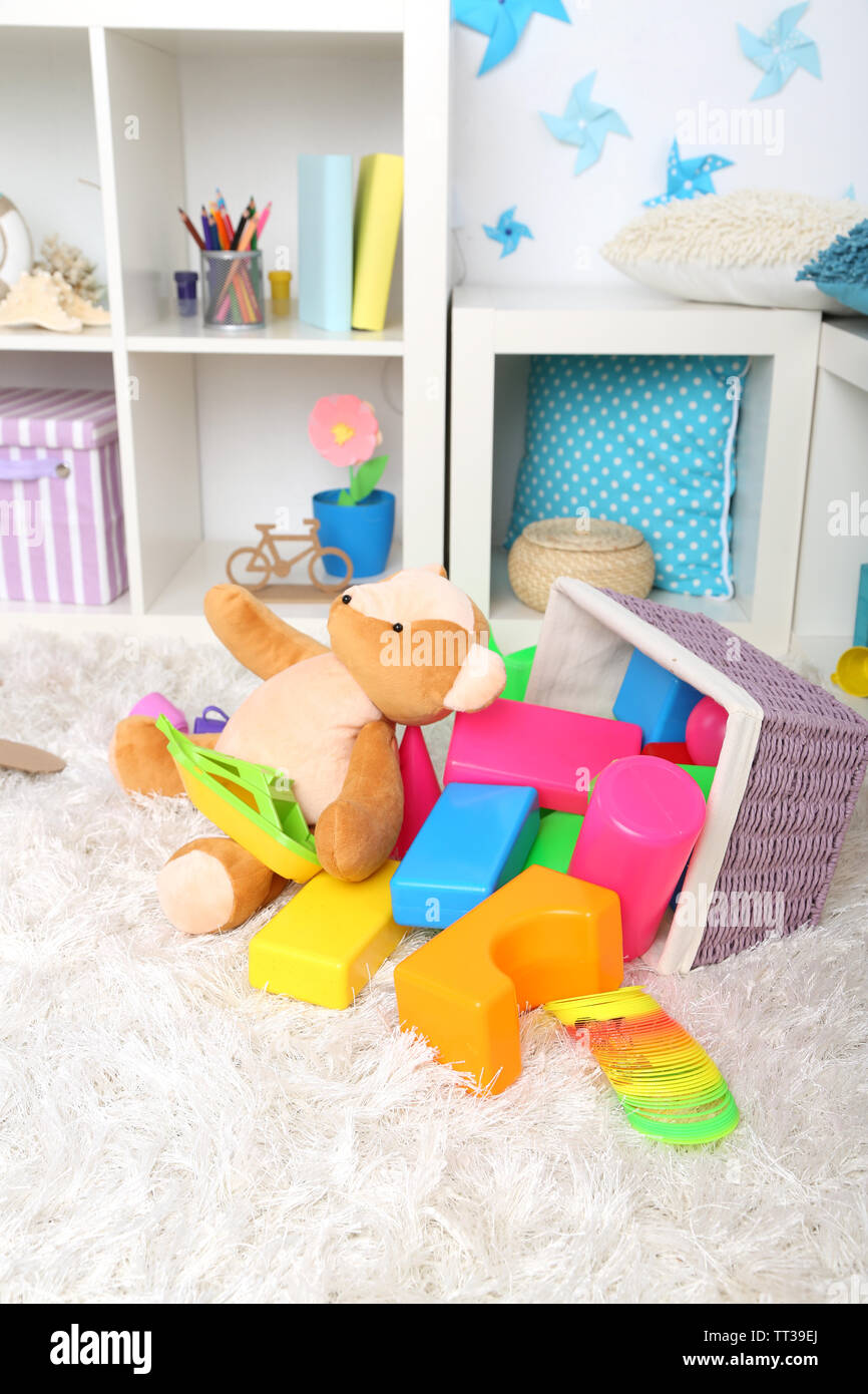 Colorful toys on fluffy carpet in children room Stock Photo - Alamy