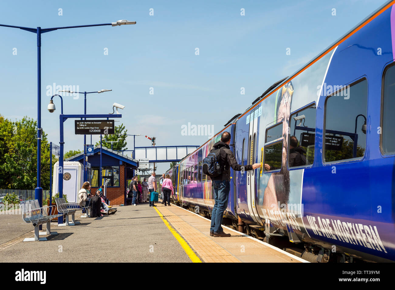 Passengers boarding a Northern Rail class 158 passenger train at Brough railway station, Yorkshire, England. Stock Photo
