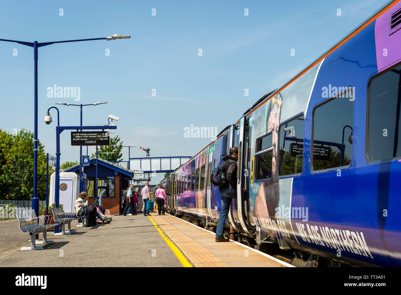 Passengers boarding a Northern Rail class 158 passenger train at Brough railway station, Yorkshire, England. Stock Photo