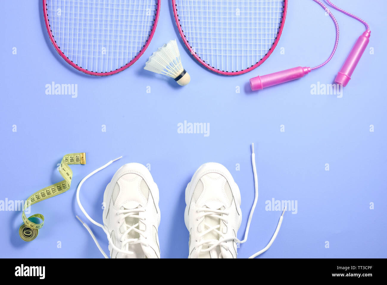 Sport equipment. Shuttlecock and badminton racket, skipping rope, sneakers  and measuring tape on purple background. Fitness, sport and healthy lifesty  Stock Photo - Alamy
