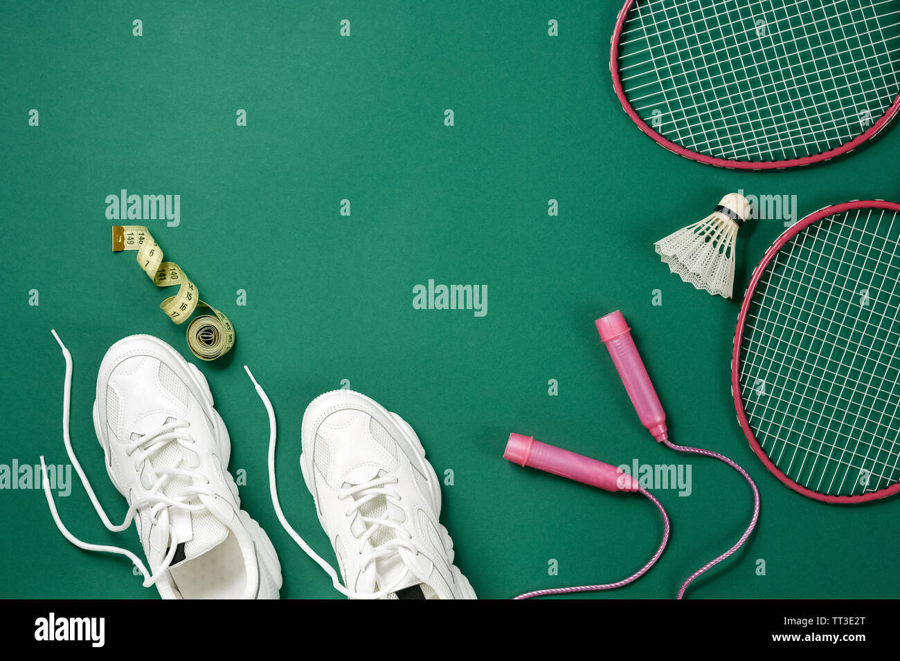Sports equipment.. Shuttlecock and badminton racket, skipping rope,  sneakers and measuring tape on green background. Fitness, sport and healthy  lifest Stock Photo - Alamy