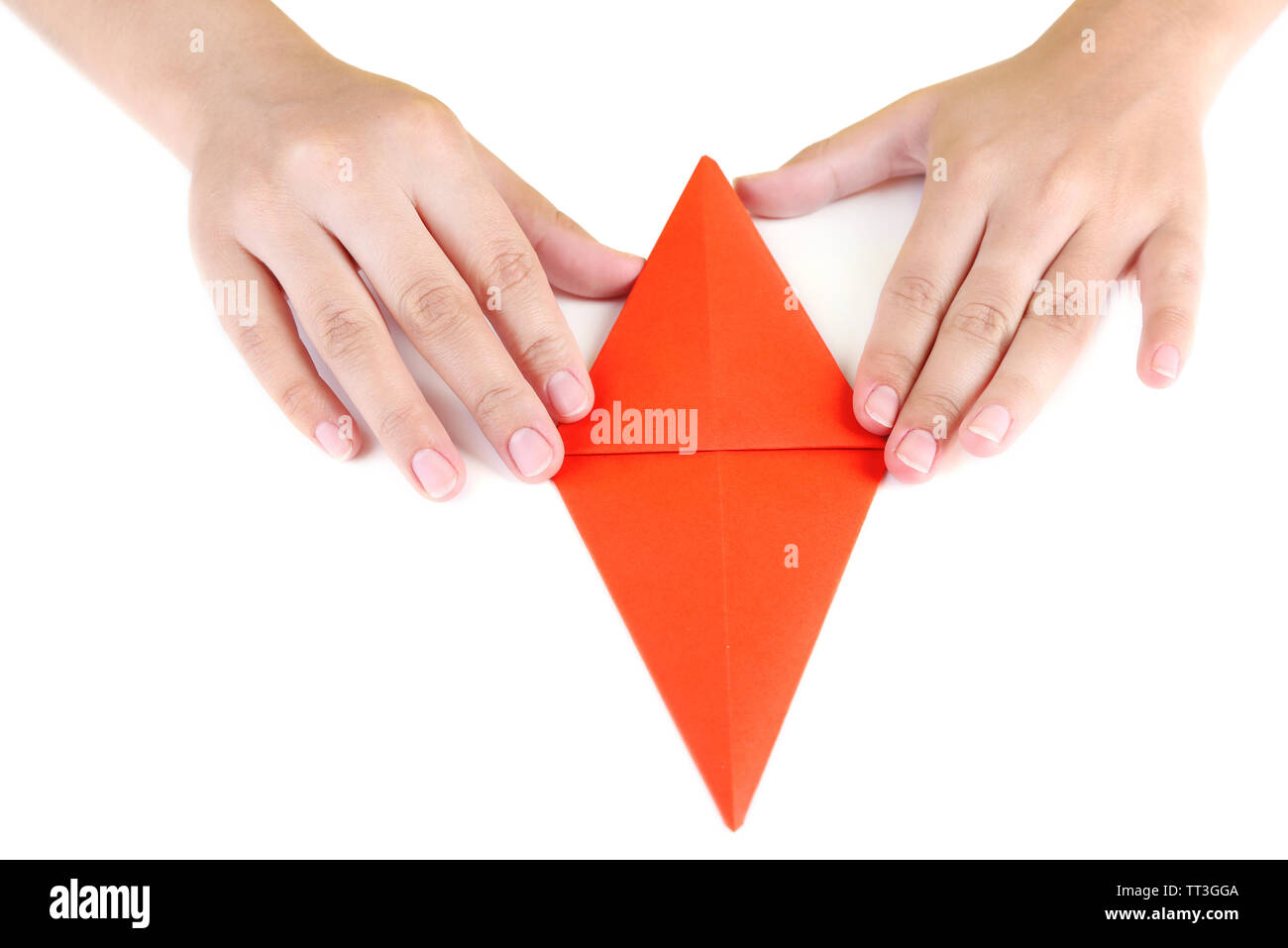 Hands making origami rabbit, close up, isolated on white Stock Photo