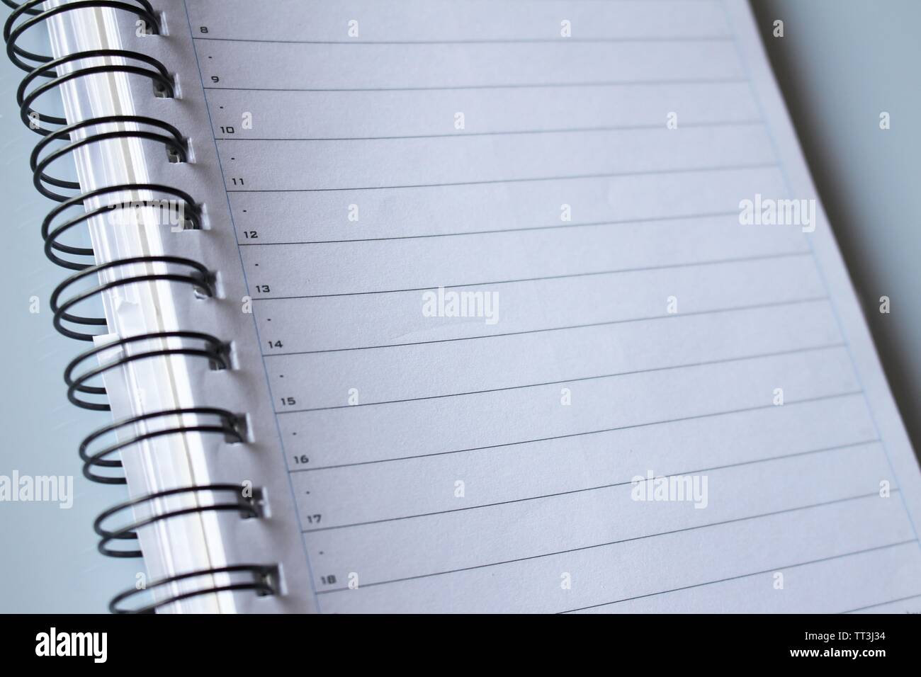 Notepad, white lined paper with calendar, spiral bound Stock Photo