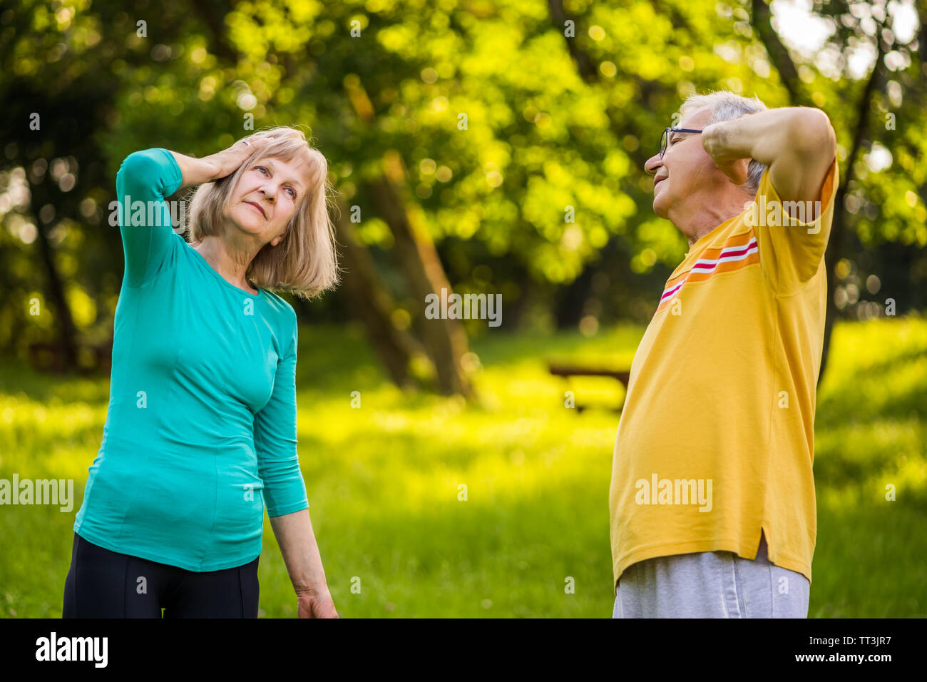 Senior couple is exercising in park. Stock Photo
