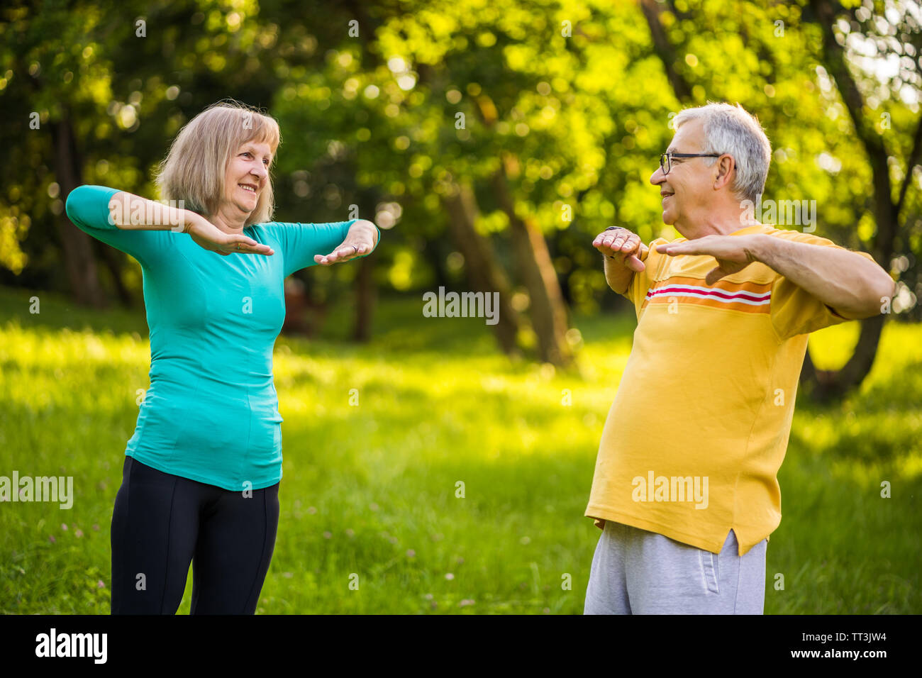 Senior couple is exercising in park Stock Photo - Alamy