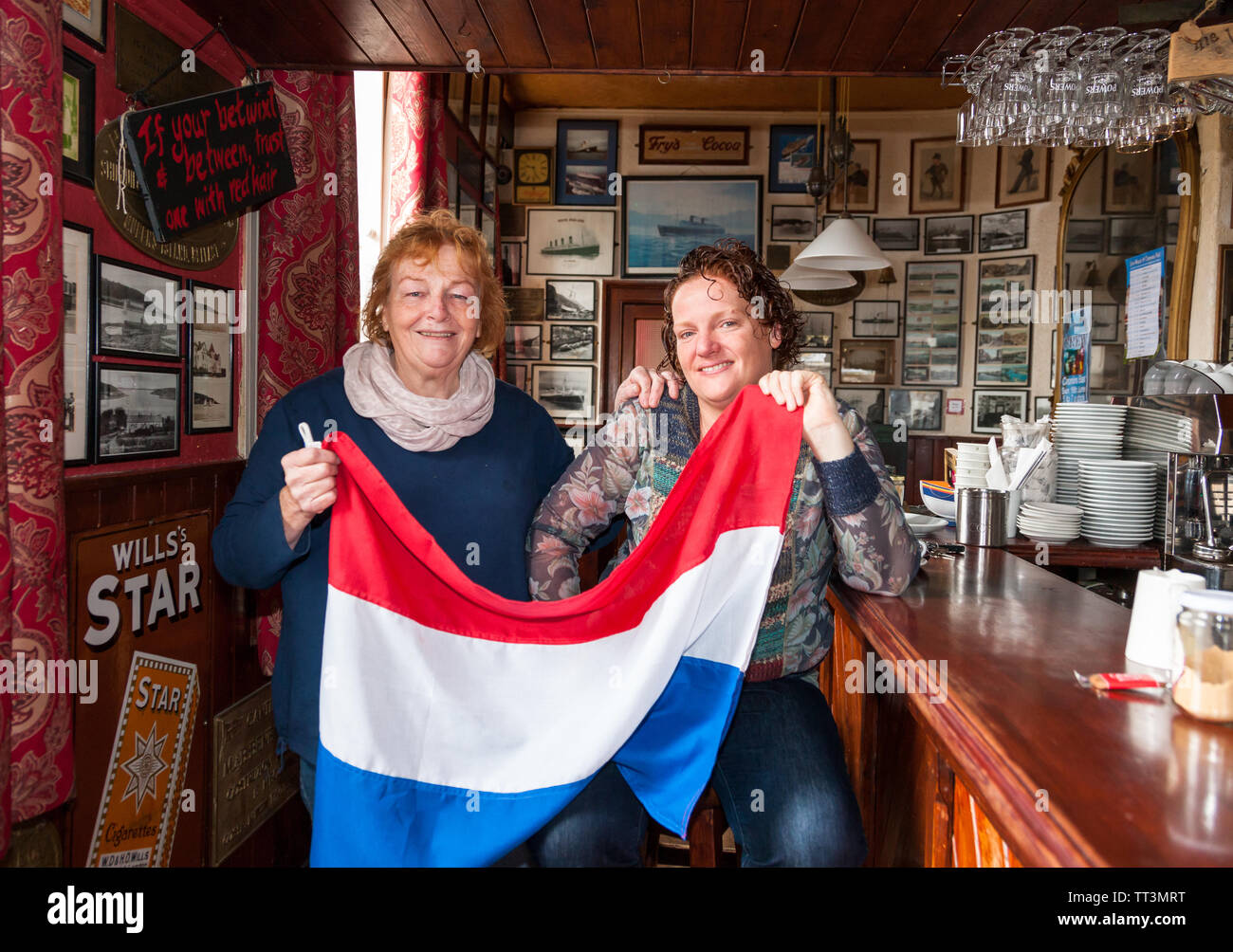 Crosshaven, Cork, Ireland. 14th June, 2019. Thecla and Joleen Cronin getting ready for the arrival of King Willem-Alexander and Queen Máxima of the Netherlands when they will visit their bar during the Royal visit to Crosshaven, Co. Cork, Ireland. Credit: David Creedon/Alamy Live News Stock Photo