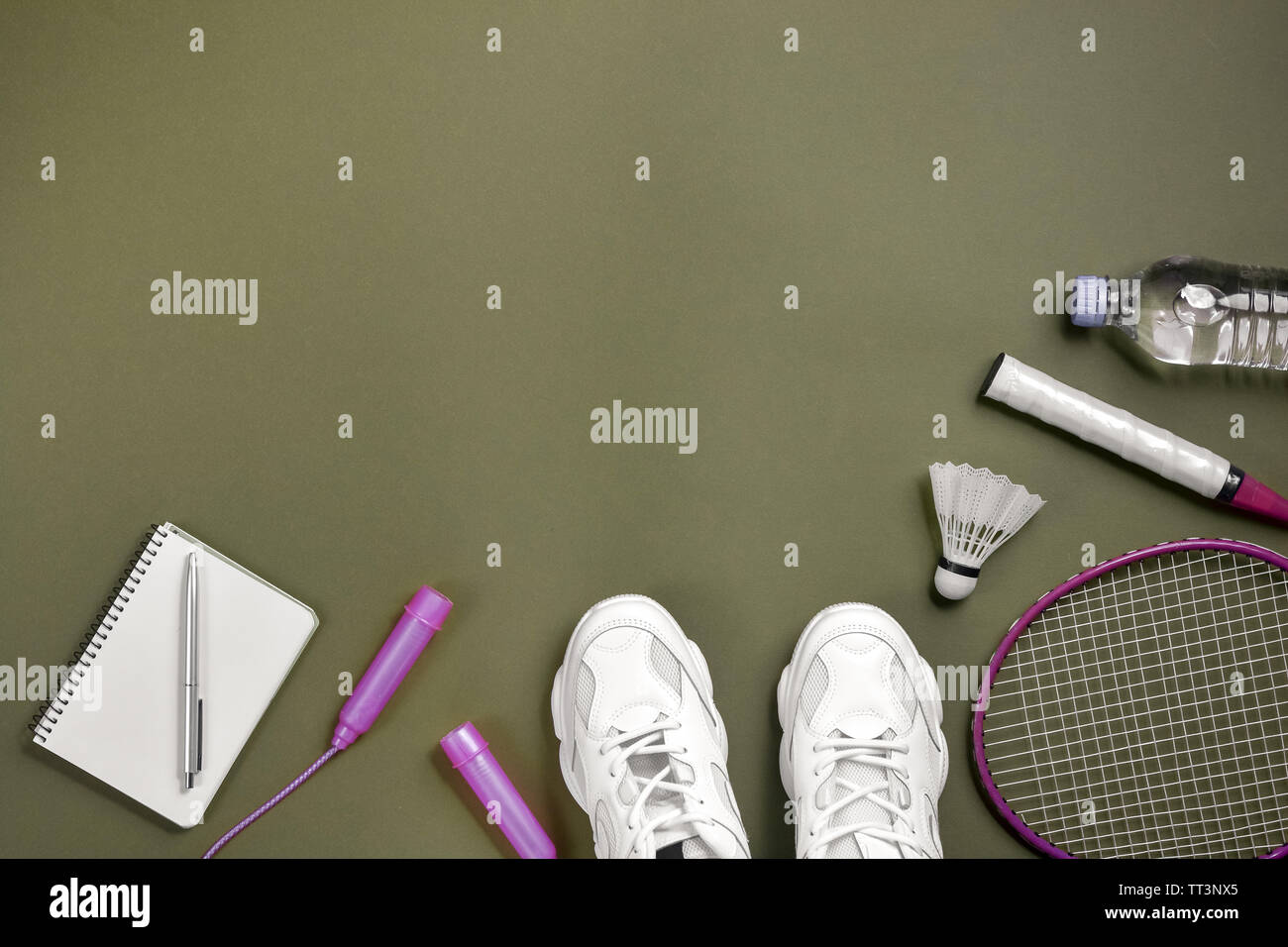 Sport equipment. Shuttlecock and badminton racket, skipping rope, sneakers,  bottle water, pen and notepad on green background. Fitness and healthy lif  Stock Photo - Alamy