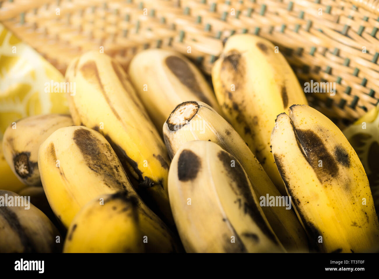 Ripe bananas.Banana with dark spots with shadow in basket.Yellow fruit. Closeup shot selective focus. Stock Photo