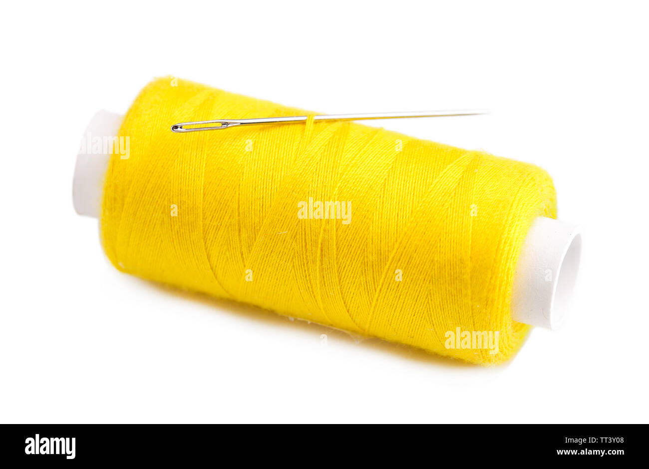 Needle and spool of thread isolated on white Stock Photo - Alamy