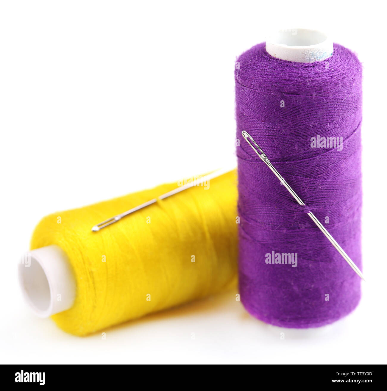 Needles and spools of thread isolated on white Stock Photo - Alamy
