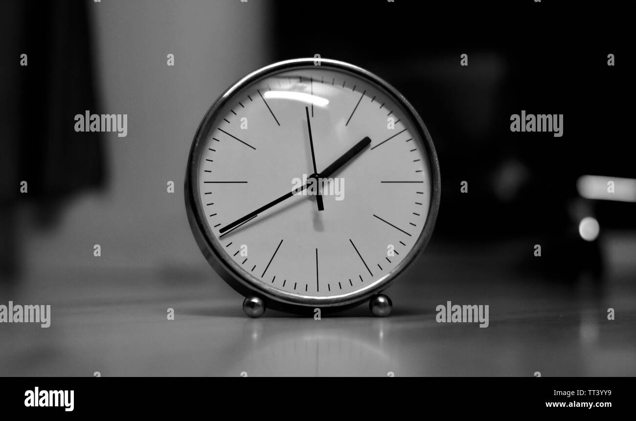 Picture of a white table clock Stock Photo Alamy